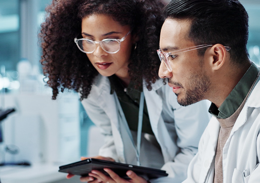 Two people working in lab gamma spectroscopy solutions